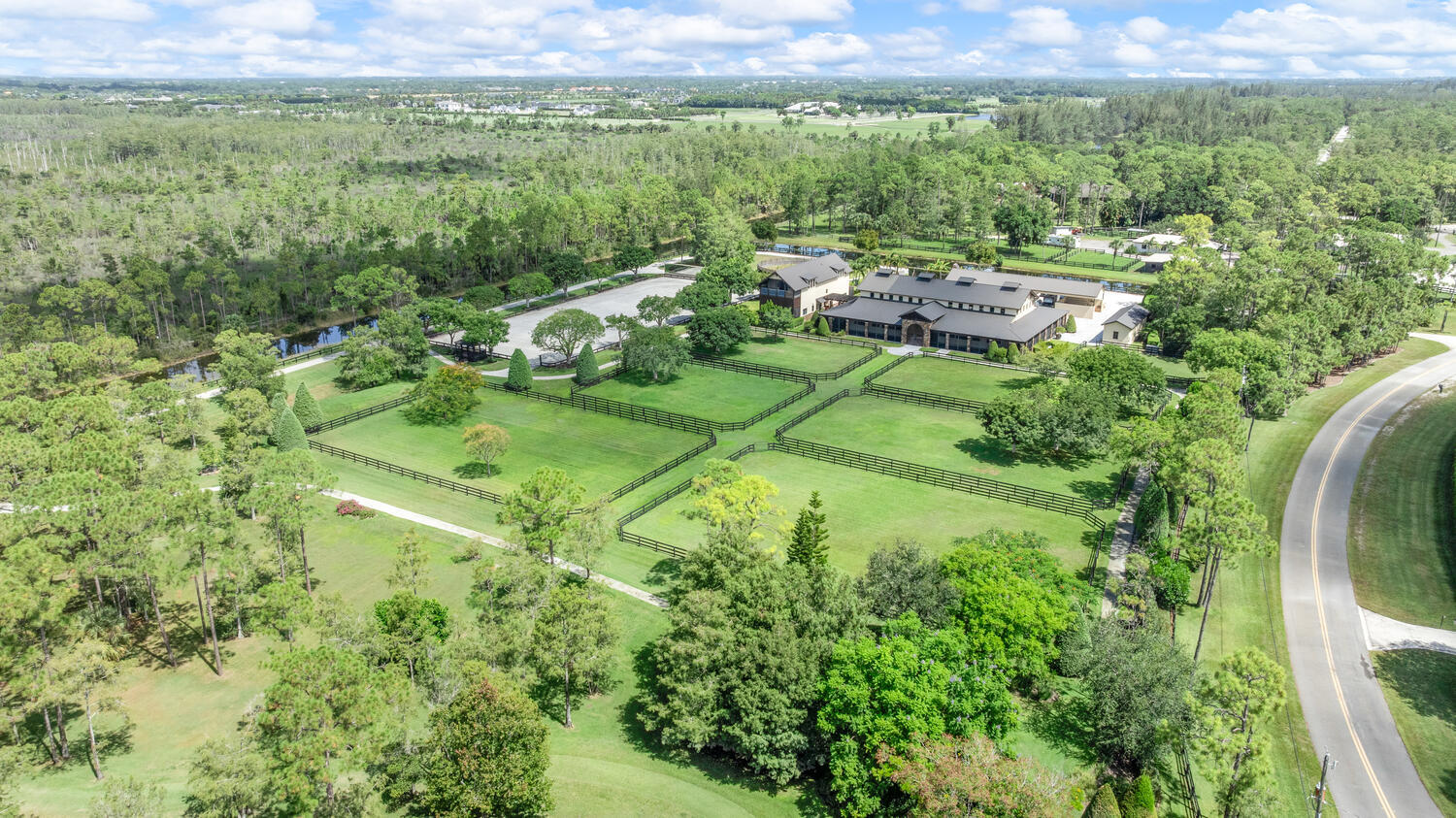 6259 Homeland Road Lake Worth, FL 33449 - Photo 4 of 62 a view of a lush green outdoor space with a lake view and mountain view
