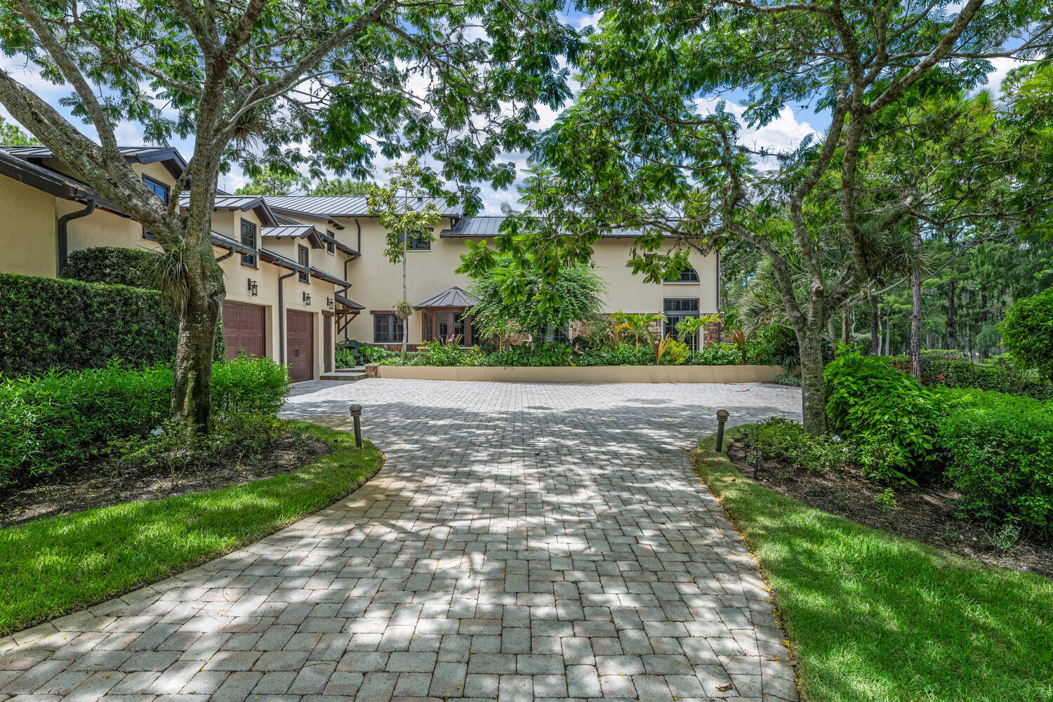6259 Homeland Road Lake Worth, FL 33449 - Photo 45 of 62 a pathway of a house with a yard and large trees