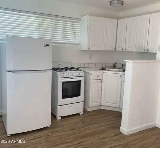 a white refrigerator freezer sitting inside of a kitchen