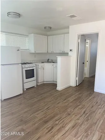 a kitchen with a refrigerator and a stove top oven