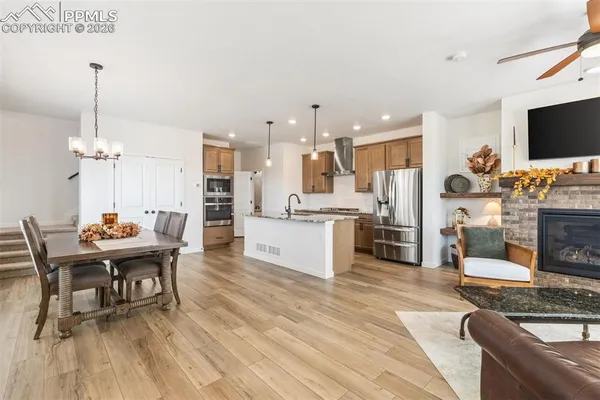 a living room with kitchen island furniture and a flat screen tv