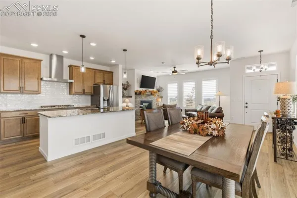 a large kitchen with a table and chairs