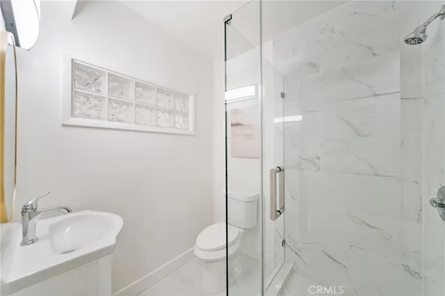 a bathroom with a shower and sink