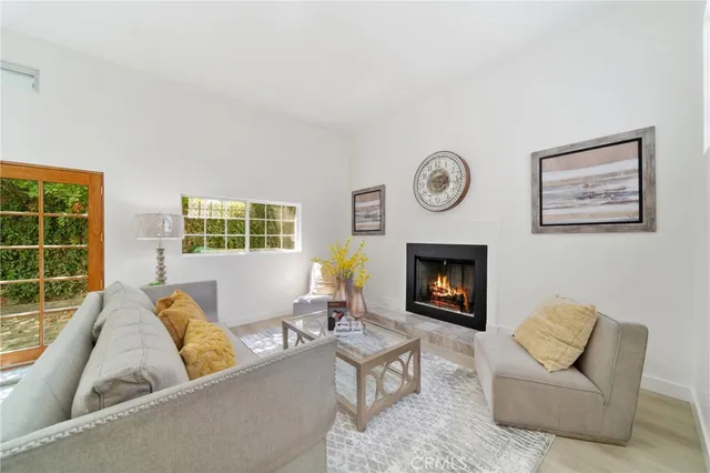 a living room with furniture a window and a fireplace