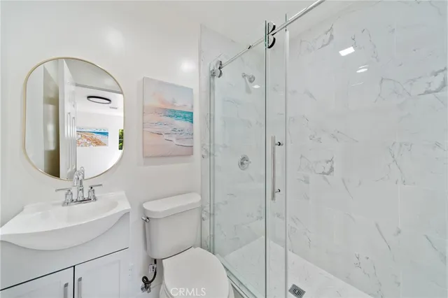 a bathroom with a toilet sink and shower
