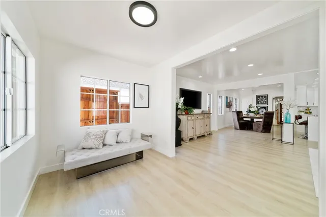 a living room with furniture and kitchen view