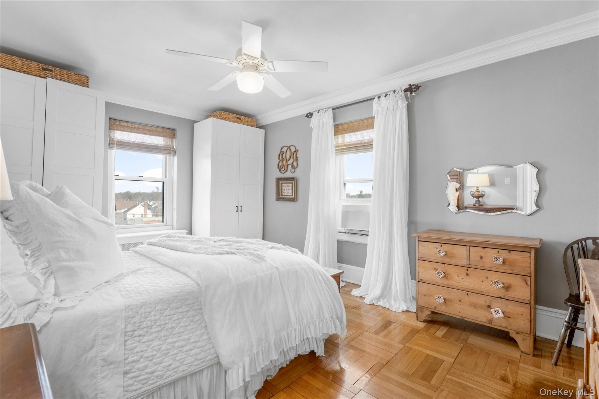 910 Stuart Avenue, Unit 4L Mamaroneck, NY 10543 - Photo 20 of 32 a bedroom with a bed and wooden floor
