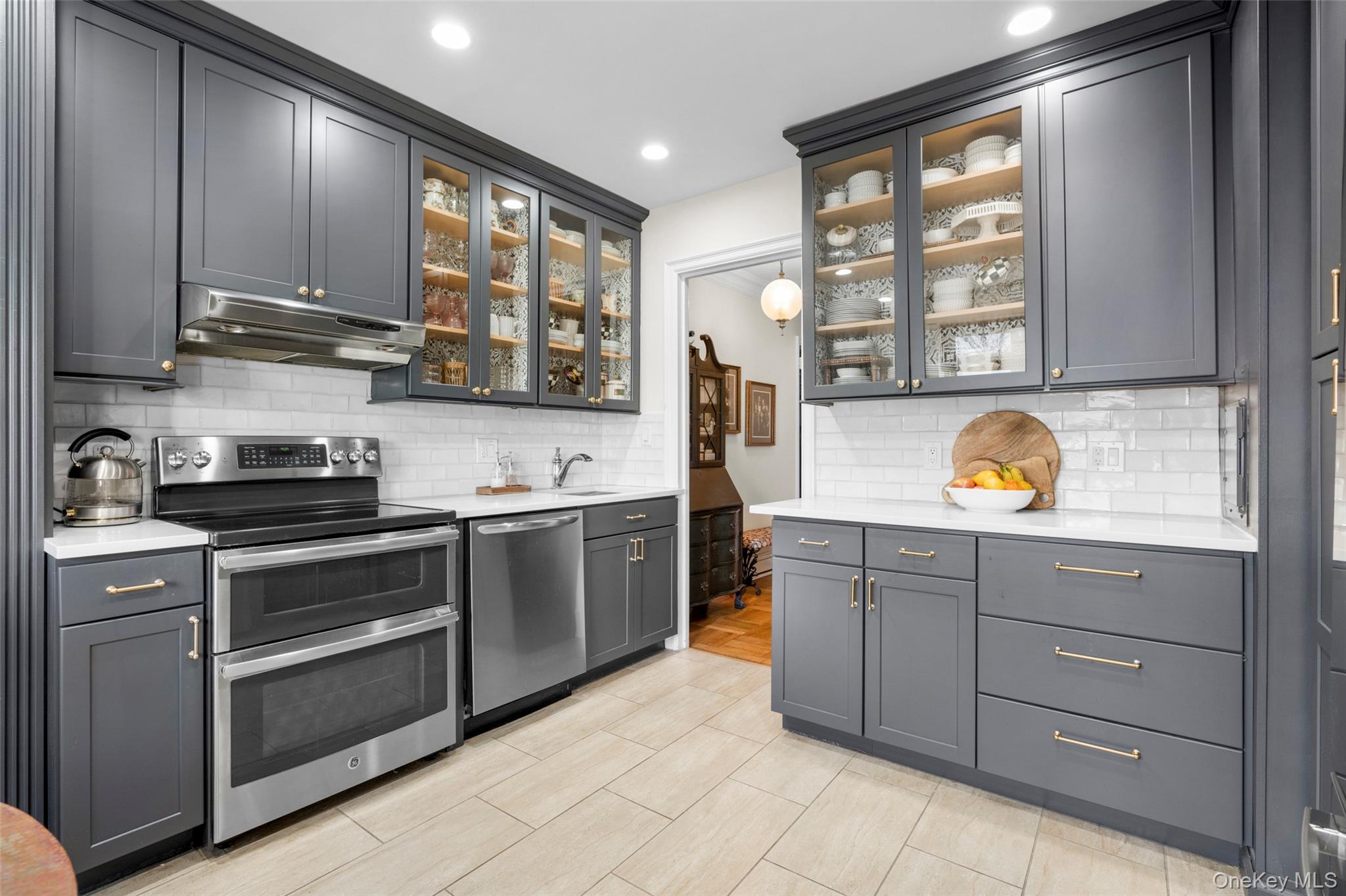 910 Stuart Avenue, Unit 4L Mamaroneck, NY 10543 - Photo 6 of 32 a kitchen with stainless steel appliances granite countertop a stove and cabinets