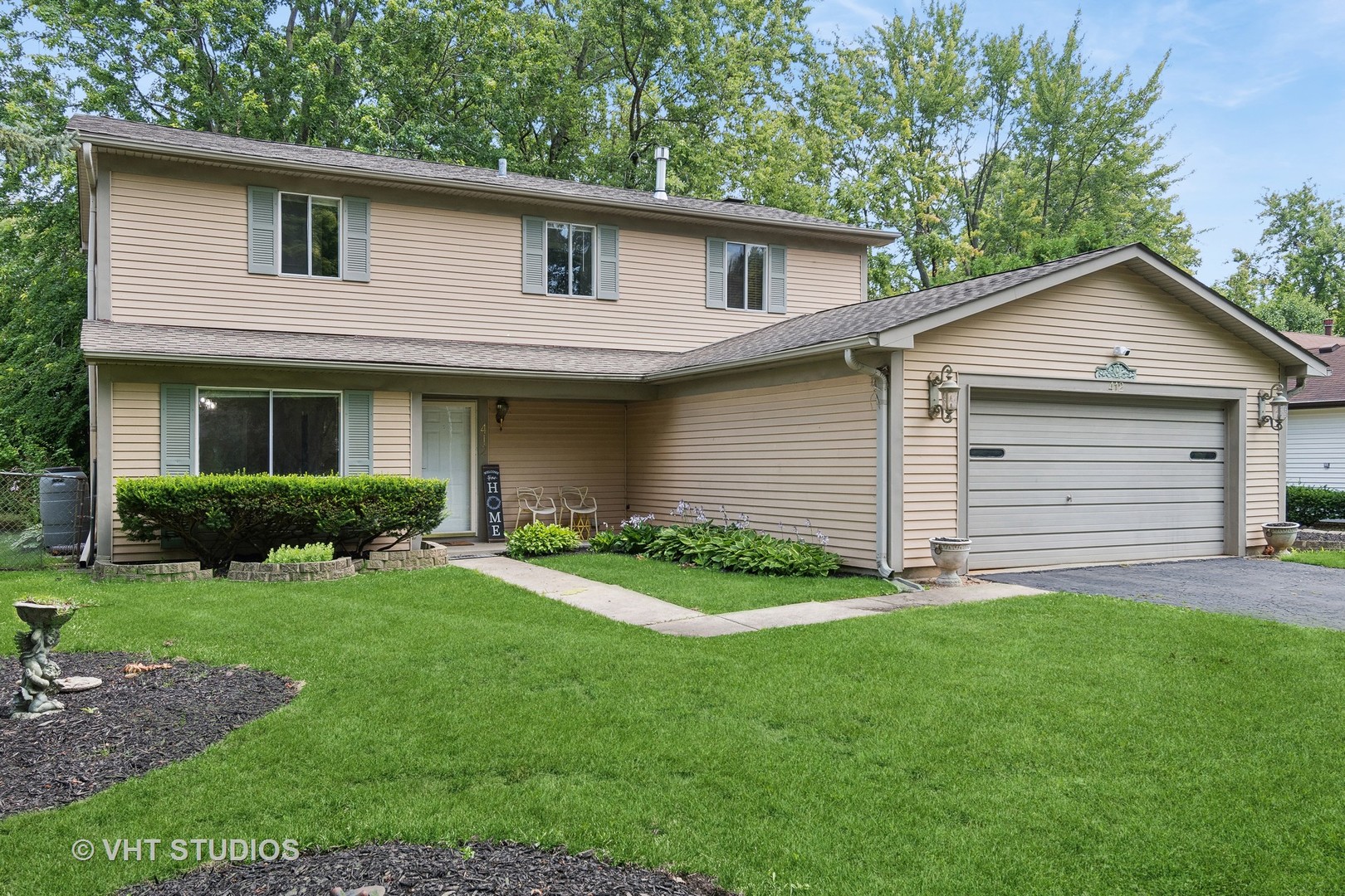 412 Quarry Drive Bolingbrook, IL 60490 - Photo 2 of 23 a front view of a house with a garden