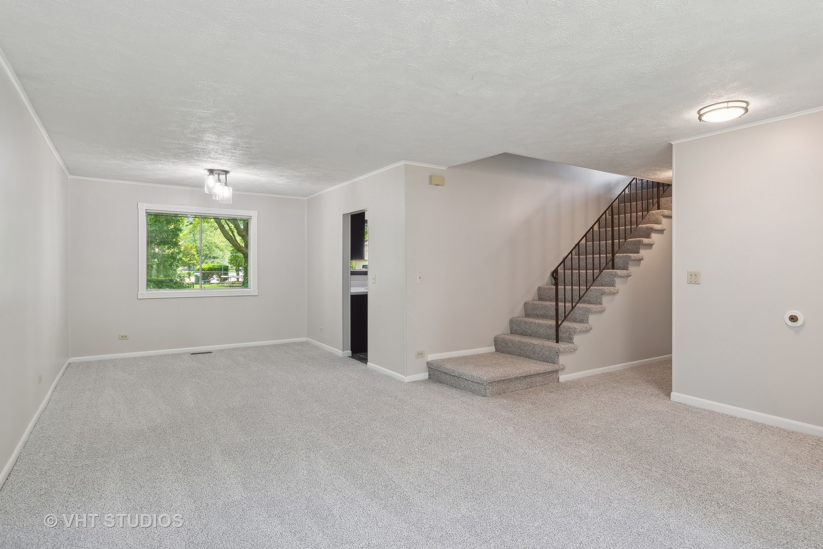 412 Quarry Drive Bolingbrook, IL 60490 - Photo 4 of 23 an empty room with windows and stairs
