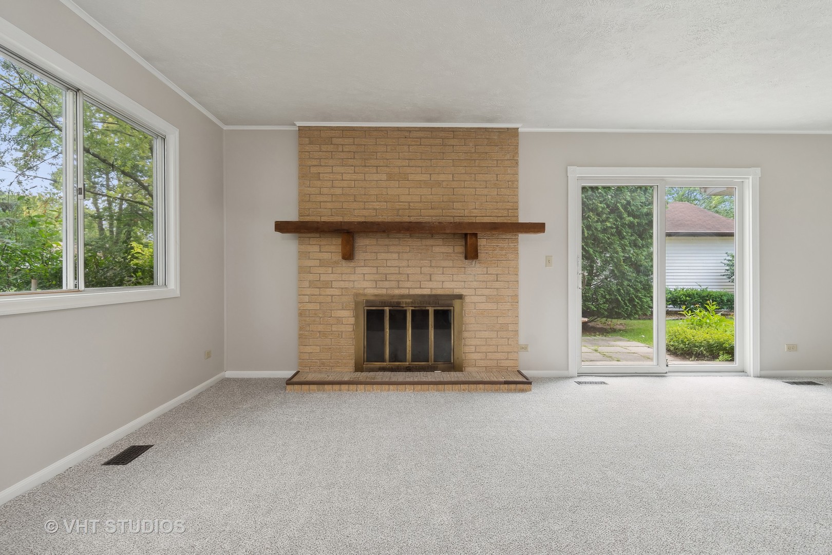 412 Quarry Drive Bolingbrook, IL 60490 - Photo 10 of 23 a view of an empty room with a fireplace and a window
