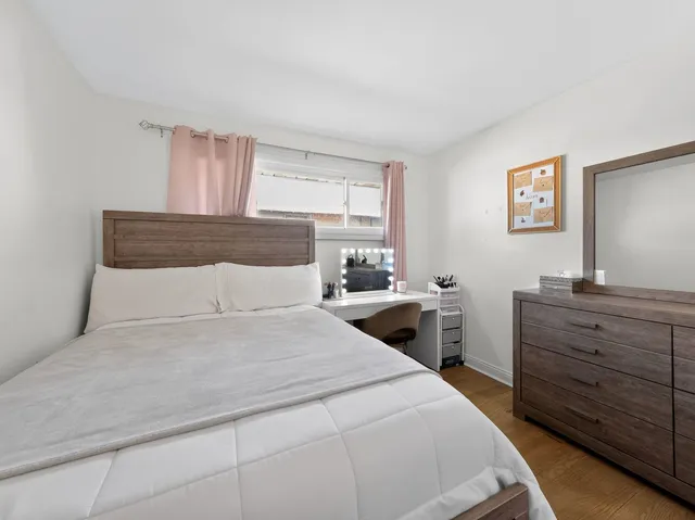 a bedroom with a large bed and a dresser