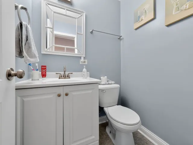 a bathroom with a toilet sink and mirror