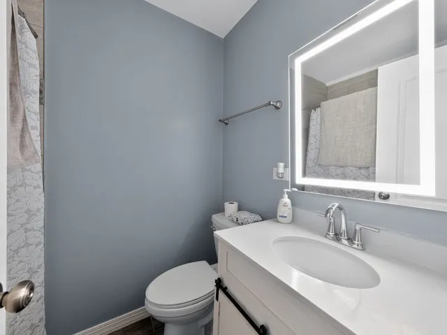 a white toilet sitting next to a bathroom sink