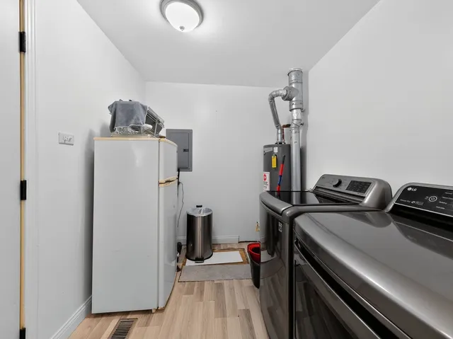 a view of a storage and utility room with washer and dryer