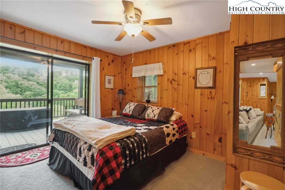710 River Hills Road Lansing, NC 28643 - Photo 22 of 38 a bed room with a bed and a chandelier