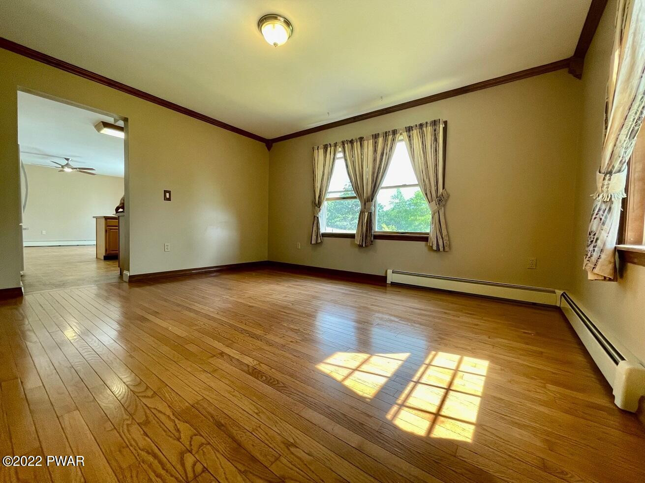 524 Creamton Drive Prompton, PA 18456 - Photo 18 of 57 an empty room with wooden floor and windows