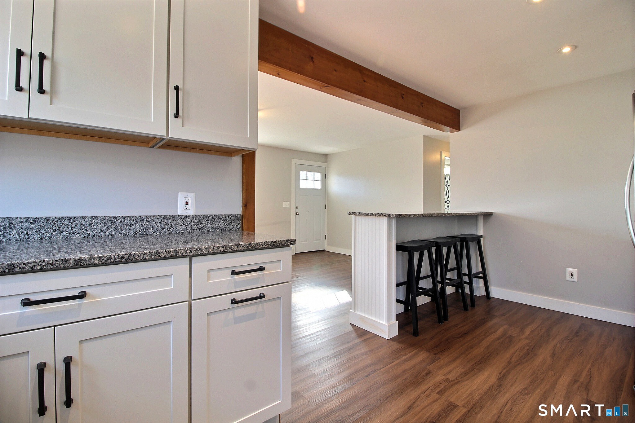 179 North Anguilla Road Stonington, CT 06379 - Photo 15 of 21 a kitchen with stainless steel appliances granite countertop a stove top oven a sink and white cabinets with wooden floor