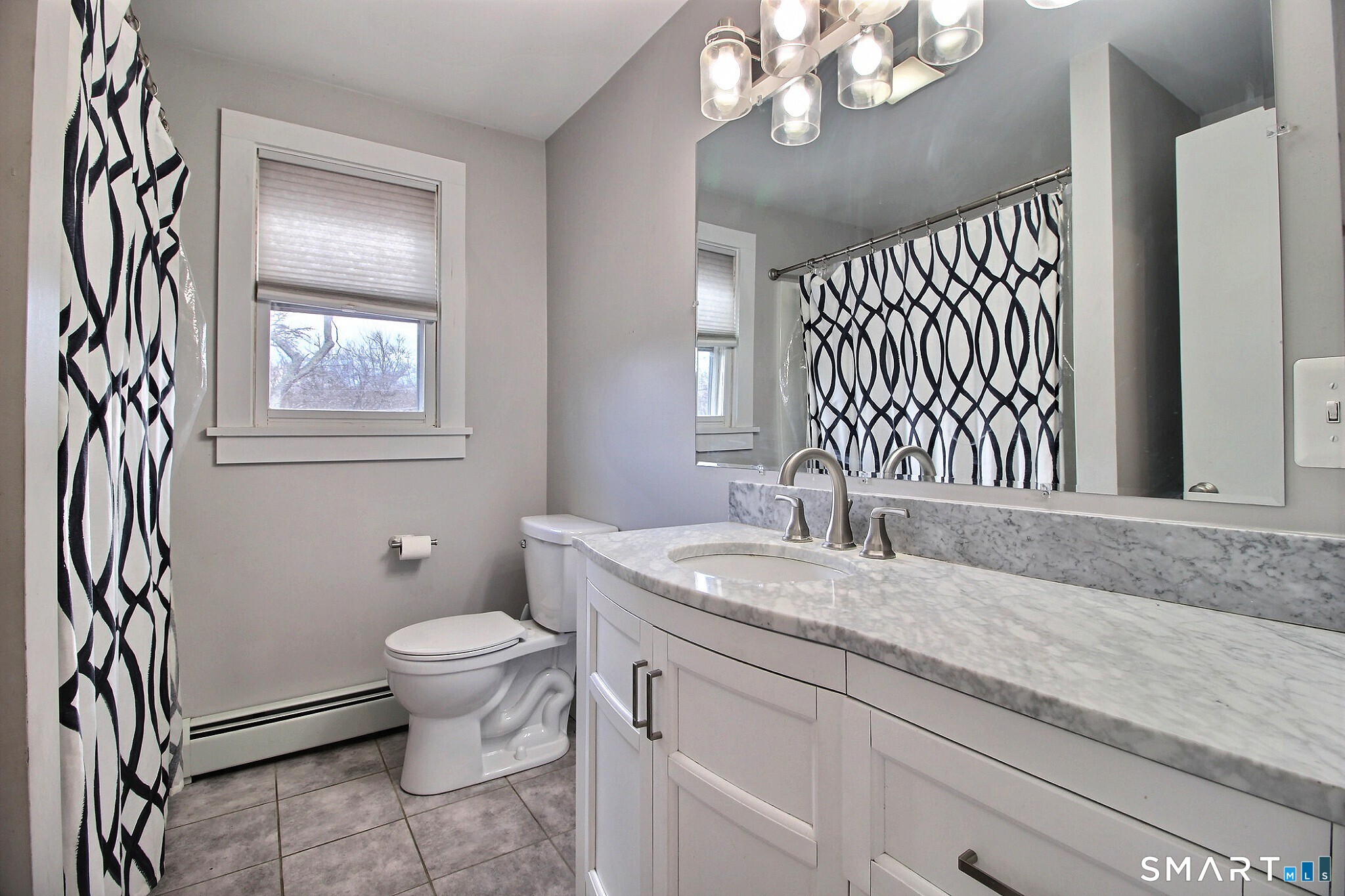 179 North Anguilla Road Stonington, CT 06379 - Photo 16 of 21 a bathroom with a granite countertop sink a toilet and a mirror