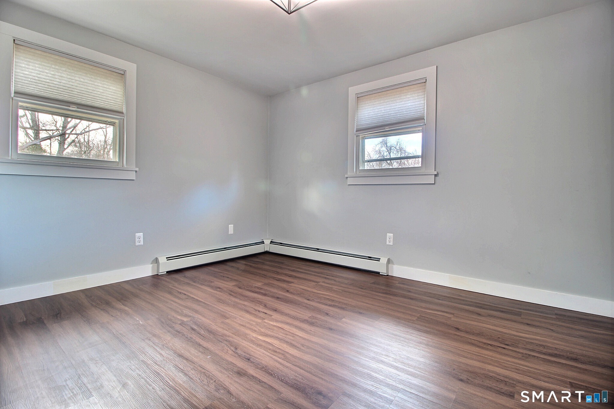 179 North Anguilla Road Stonington, CT 06379 - Photo 18 of 21 an empty room with wooden floor and windows