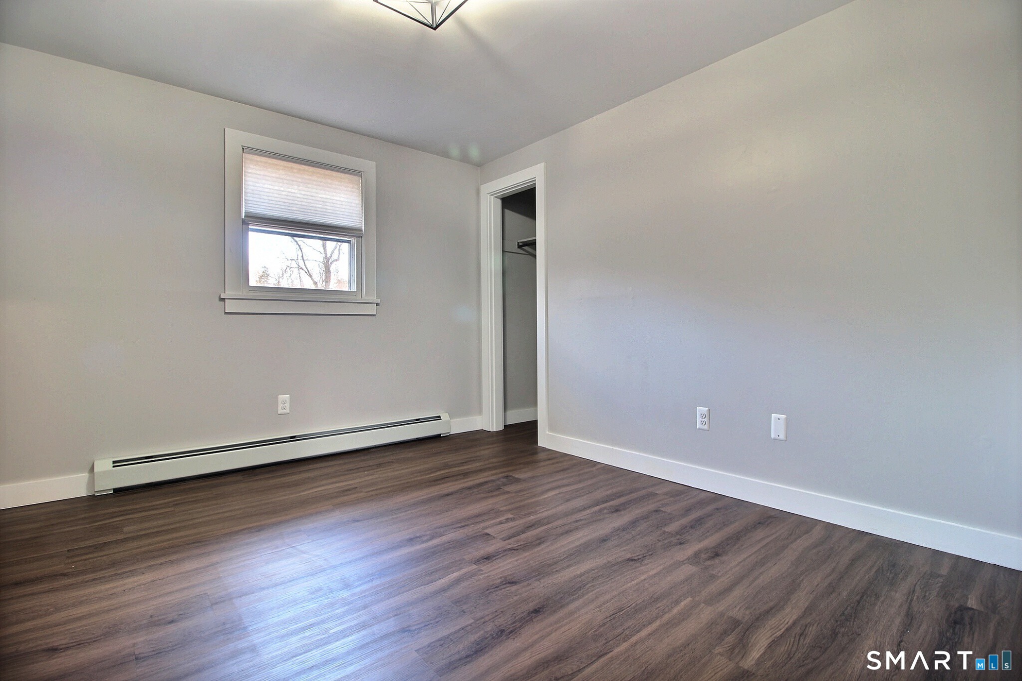 179 North Anguilla Road Stonington, CT 06379 - Photo 19 of 21 a view of an empty room with wooden floor and a window