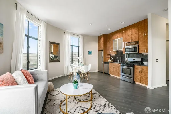 a living room with furniture kitchen and a table