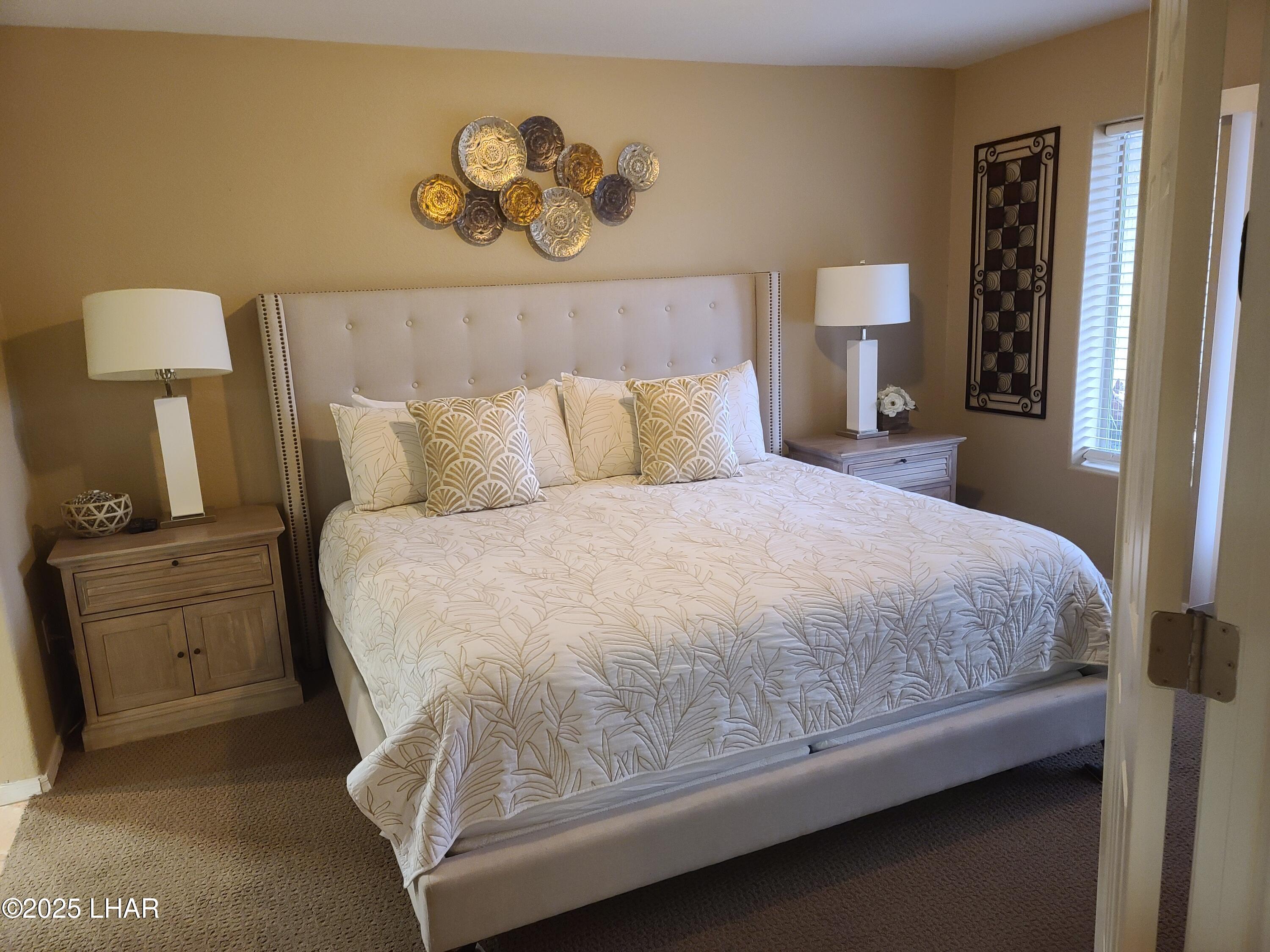 94 London Bridge Road, Unit 108 Lake Havasu City, AZ 86403 - Photo 22 of 38 a bedroom with a bed and a night stand