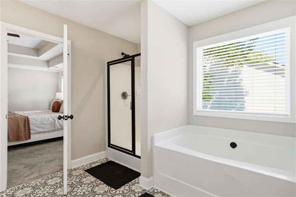 189 Marie Court Bethlehem, GA 30620 - Photo 15 of 57 a bathroom with a tub shower and a window