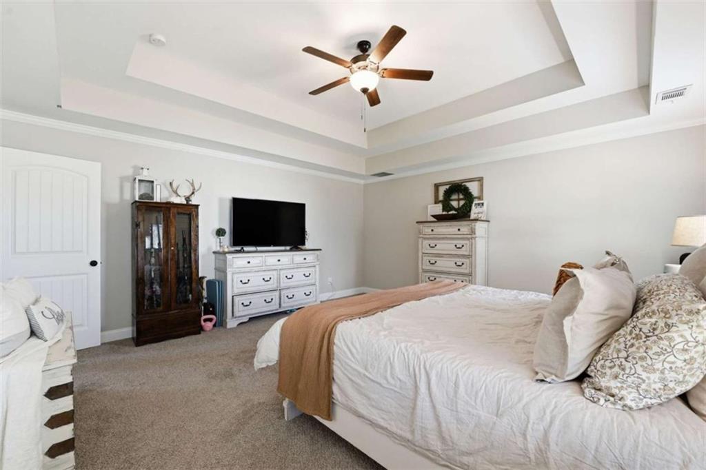 189 Marie Court Bethlehem, GA 30620 - Photo 16 of 57 a bedroom with a bed and a flat screen tv