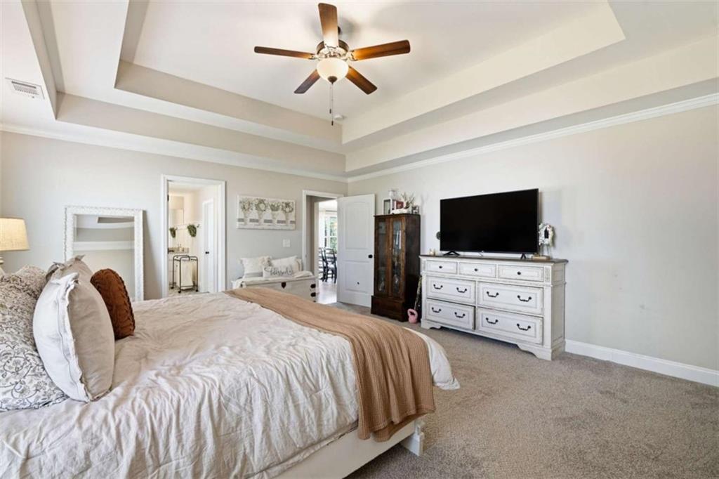 189 Marie Court Bethlehem, GA 30620 - Photo 18 of 57 a bedroom with a bed and a flat tv screen on dresser