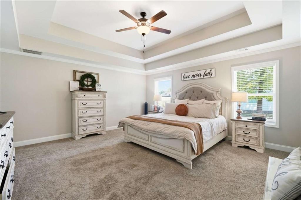 189 Marie Court Bethlehem, GA 30620 - Photo 19 of 57 a bedroom with a bed and a chandelier