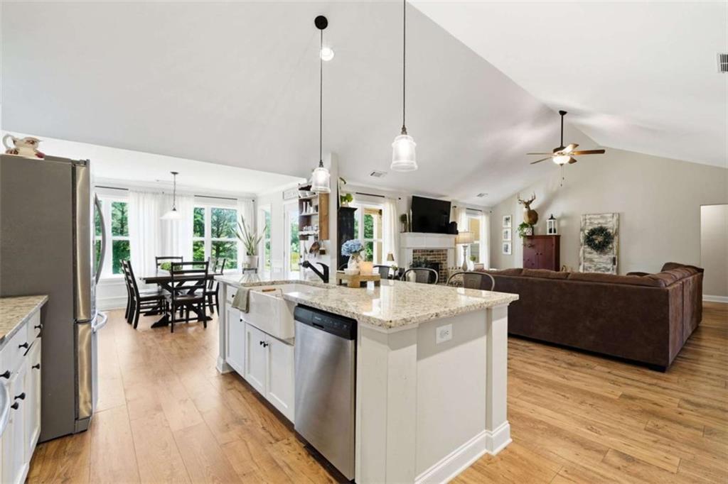 189 Marie Court Bethlehem, GA 30620 - Photo 21 of 57 a kitchen with kitchen island a stove a counter top space and a dining table