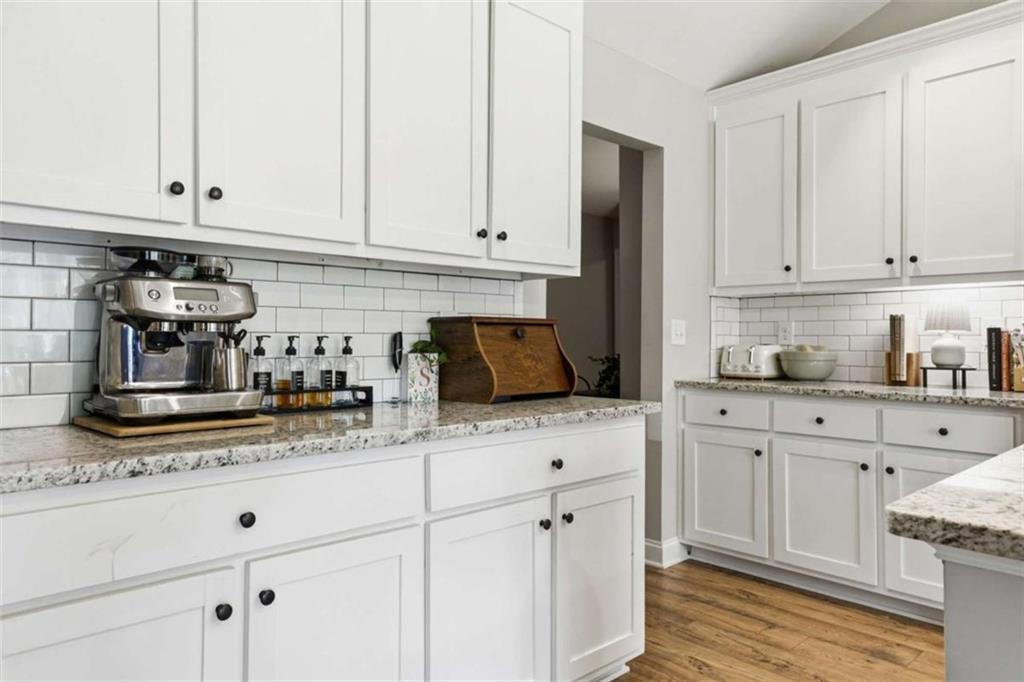 189 Marie Court Bethlehem, GA 30620 - Photo 22 of 57 a kitchen with granite countertop white cabinets and white appliances