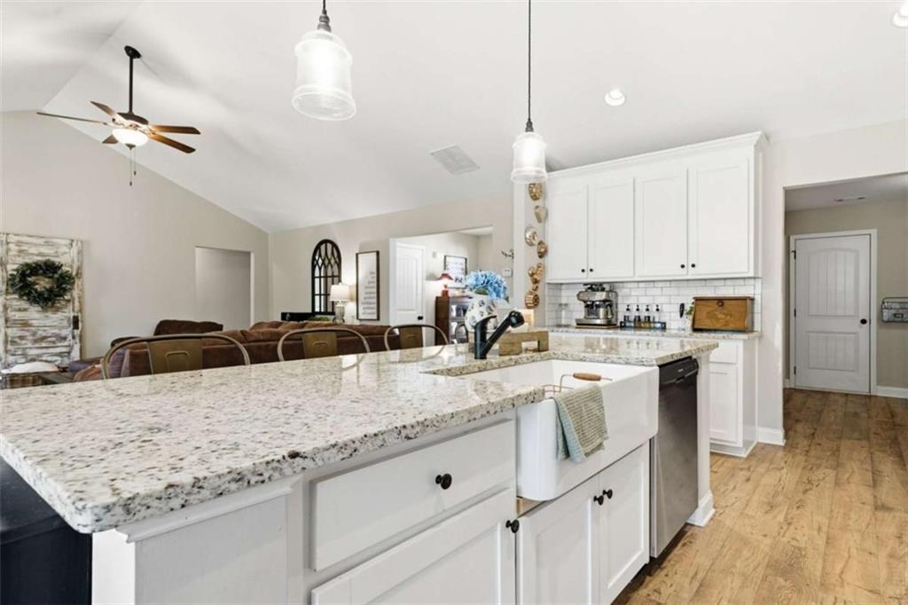 189 Marie Court Bethlehem, GA 30620 - Photo 26 of 57 a kitchen with center island white cabinets and refrigerator