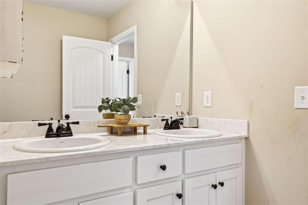 189 Marie Court Bethlehem, GA 30620 - Photo 45 of 57 a bathroom with a sink and a mirror