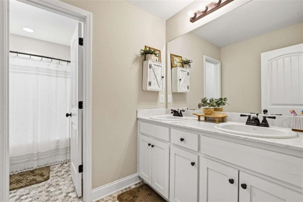 189 Marie Court Bethlehem, GA 30620 - Photo 46 of 57 a bathroom with a double vanity sink mirror and shower