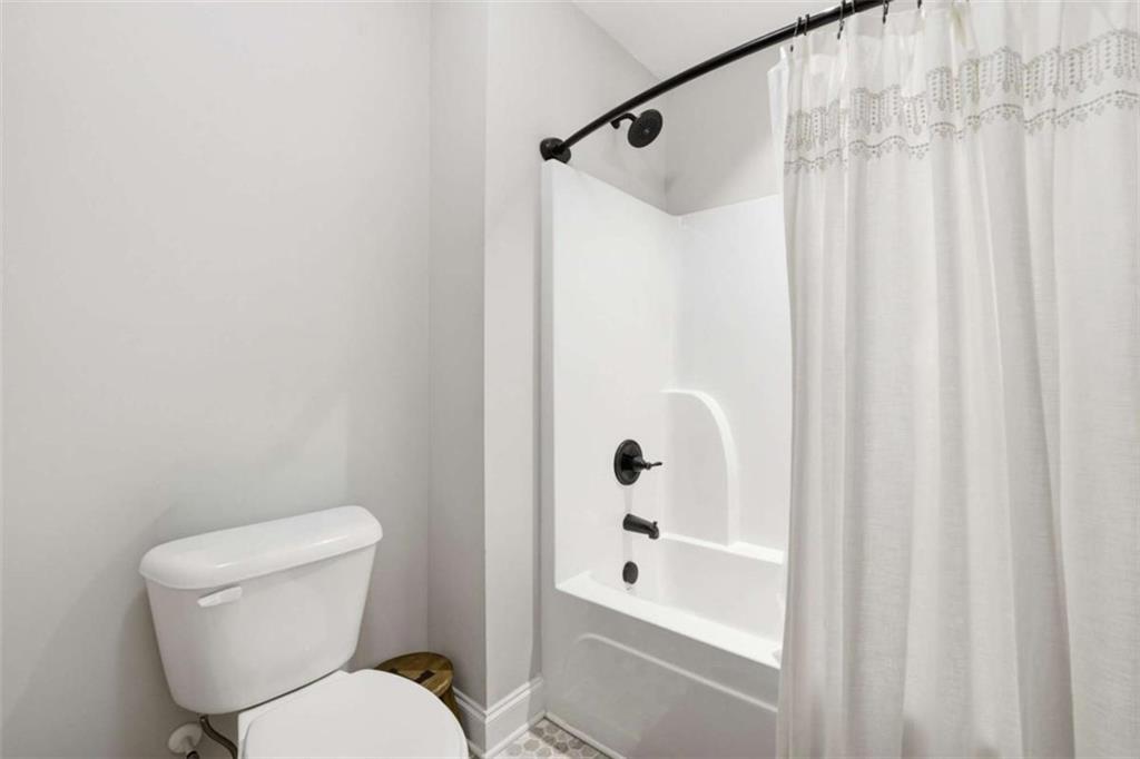 189 Marie Court Bethlehem, GA 30620 - Photo 47 of 57 a white toilet sitting next to a bathroom sink