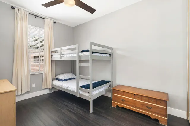 a bedroom with a bunk bed and a window