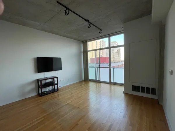 a view of room with hardwood floor and window