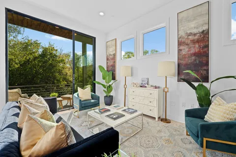 a living room with furniture and a large window