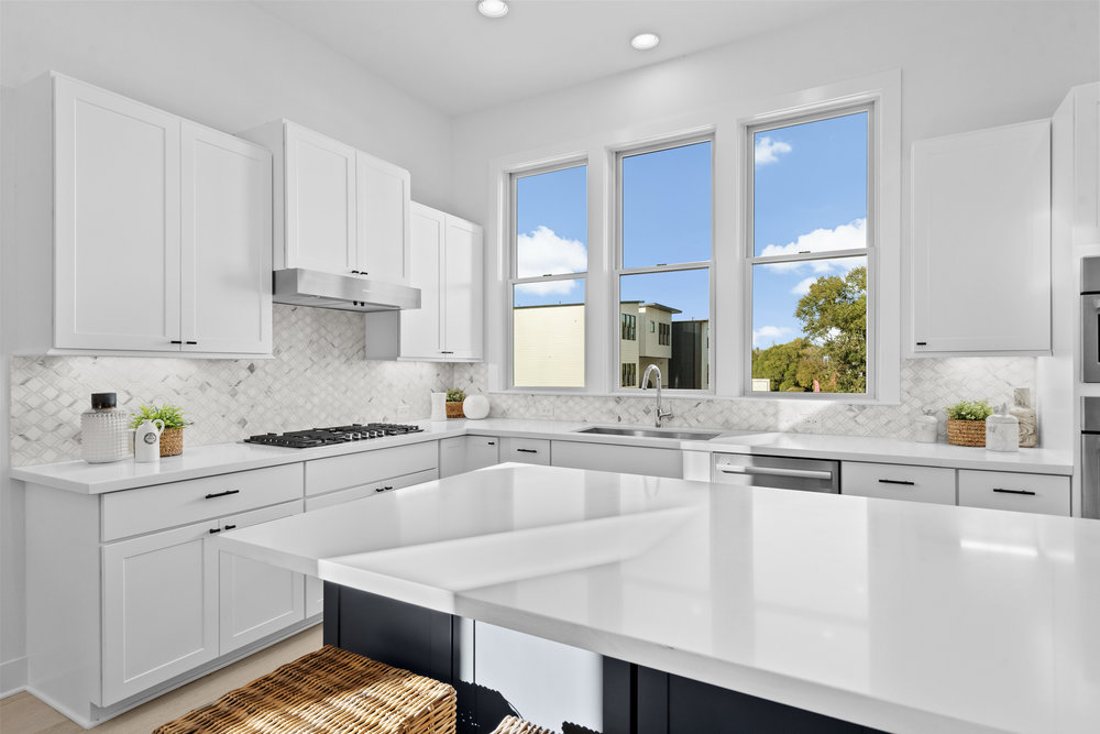 5001 Childers Path Austin, TX 78741 - Photo 15 of 40 Kitchen with white cabinets, tasteful backsplash, light stone countertops, recessed lighting, and under cabinet range hood