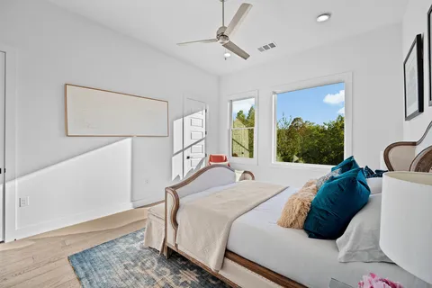 a bedroom with a bed window and a rug