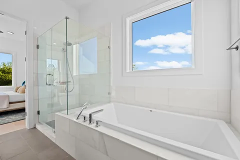 a bathroom with a tub and a shower