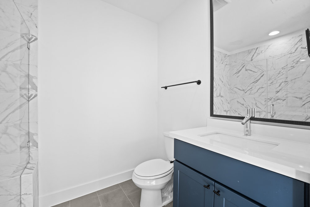 5001 Childers Path Austin, TX 78741 - Photo 29 of 40 Bathroom featuring vanity, a marble finish shower, tile patterned floors, and recessed lighting