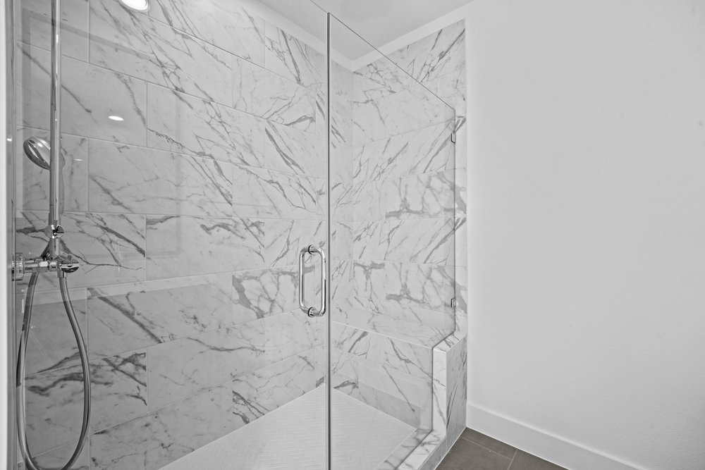 5001 Childers Path Austin, TX 78741 - Photo 30 of 40 Bathroom featuring a marble finish shower and baseboards