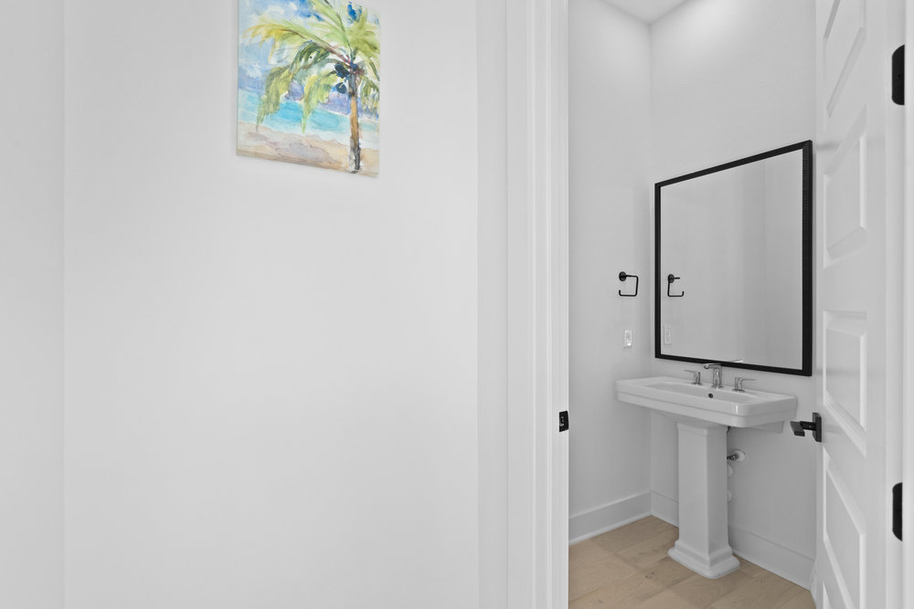 5001 Childers Path Austin, TX 78741 - Photo 32 of 40 Bathroom featuring light wood-style floors and baseboards
