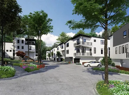 an aerial view of a residential apartment building with a yard and plants