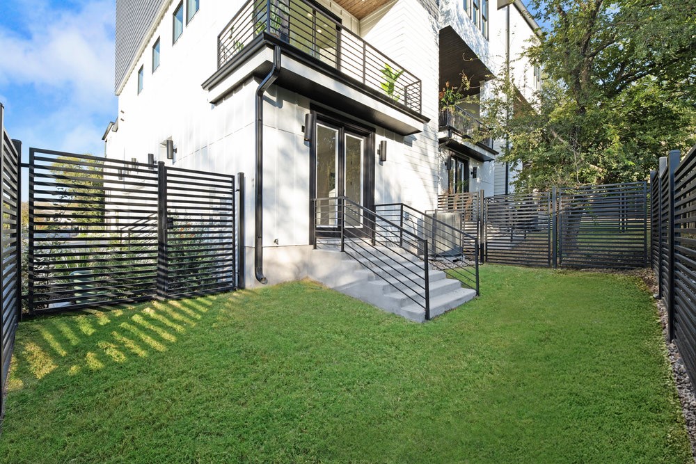 5001 Childers Path Austin, TX 78741 - Photo 9 of 40 Back of property featuring a fenced backyard and a balcony