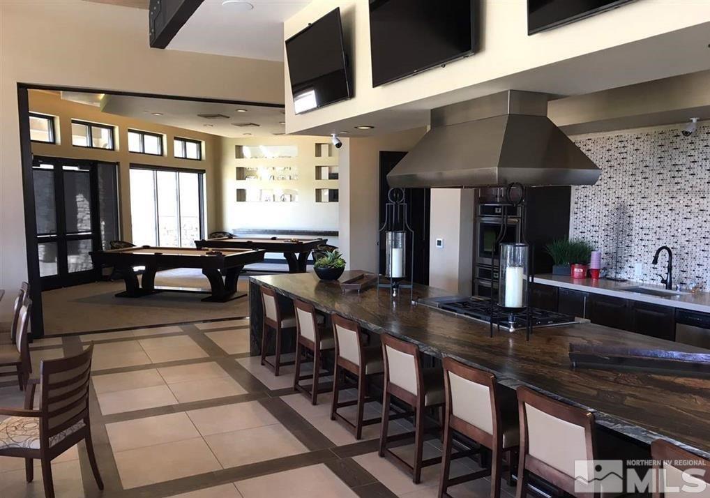 9840 Nahar Lane Reno, NV 89521 - Photo 25 of 25 a kitchen with a table chairs and a stove
