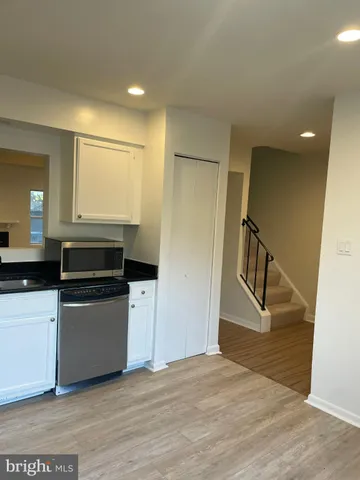 a kitchen with a refrigerator and a sink